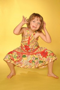 Young girl posing on yellow background
