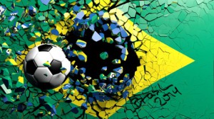 Soccer ball breaking though wall with Brazilian flag